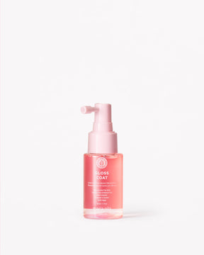 Pink Gloss Coat Travel bottle with pump on a white background